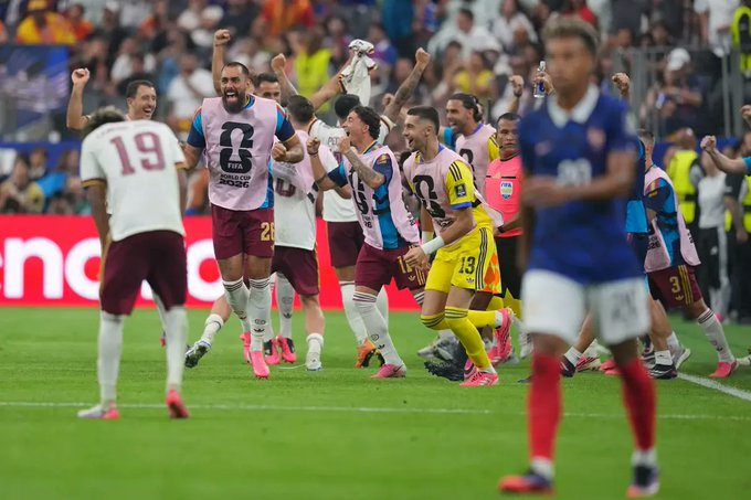Argentina players celebrate on the touchline during a 2026 FIFA World Cup match, with a France player visible in the foreground